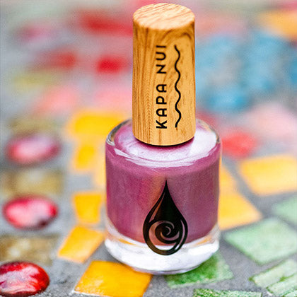 evening orchid non toxic nail polish bottle laying on mosaic tiles