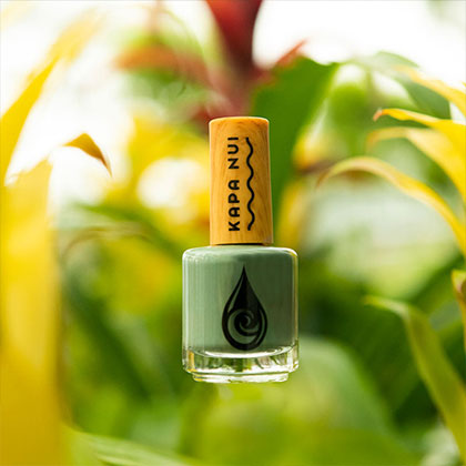 naupaka nail polish sitting in green leaves