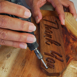 hand carving a piece of wood with tool