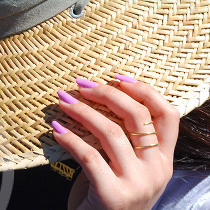 sweet wahine wearing sweet wahine non toxic nail polish touching her hat