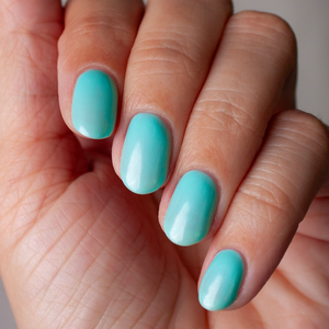 non toxic nail polish blue jade hand swatch with bottle