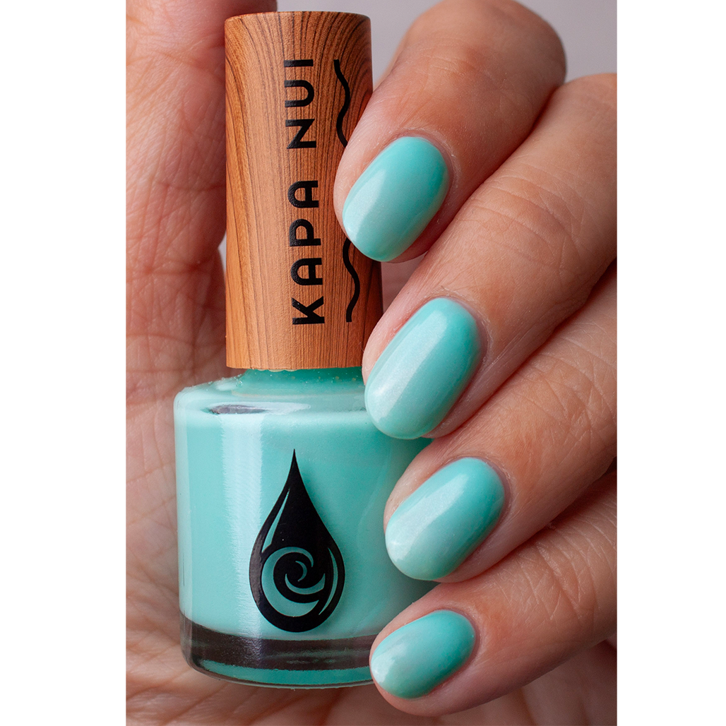 water based nail polish blue jade hand swatch with bottle