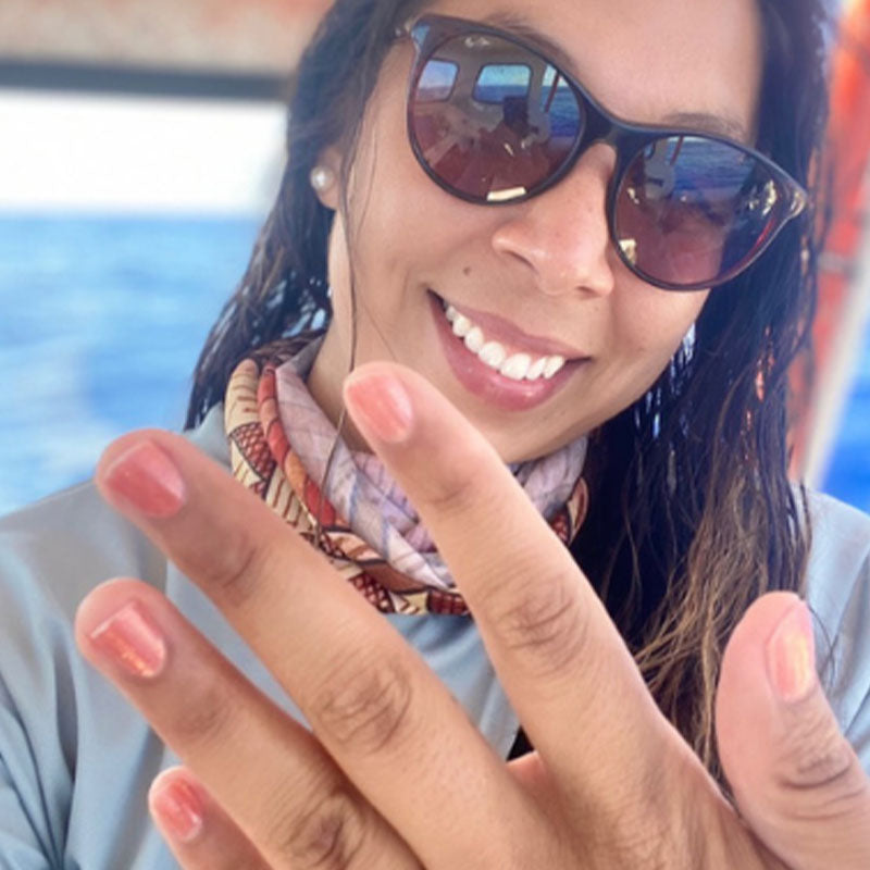 woman showing her hands painted with blushing sun natural nail polish