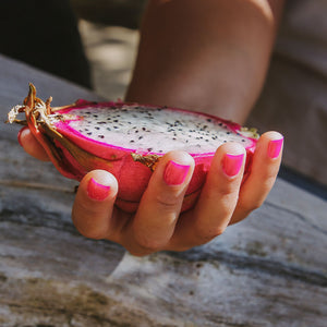 hand holding dragon fruit
