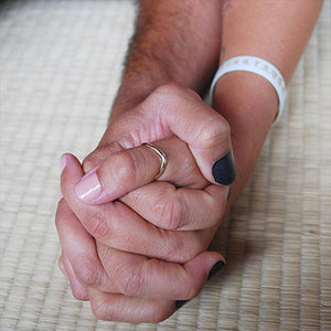 couple holding hands wearing natural nail polish