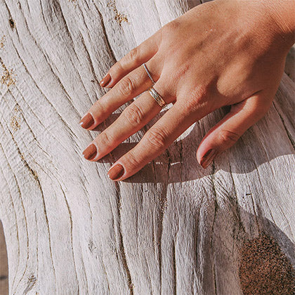 hand model wearing natural non toxic nail polish in kopaa color hand on tree