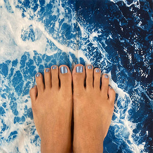 lani non toxic nail polished toes on top of  picture of a wave