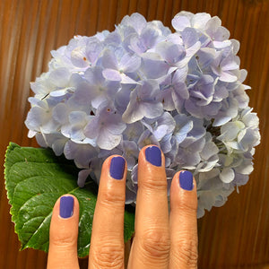 water based nail polish liliu hand model holding purple flower