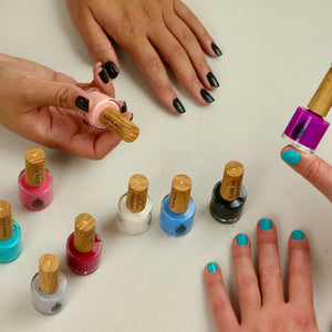 women holding fruit wearing kapa nui nails non toxic nail polish