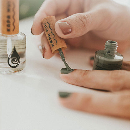 woman applying naupaka natural nail polish