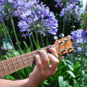 guitar player wearing new moon natural nail polish