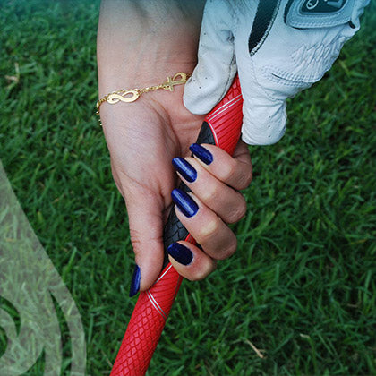 woman holding golf club wearing big island nights non toxic nail polish