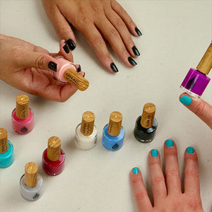 multiple color bottles of kapa nui non toxic nail polish on a table