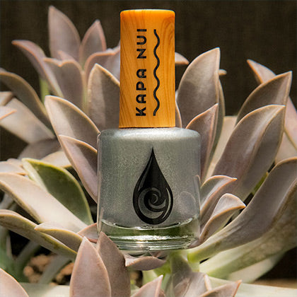 non toxic nail polish  in aholehole color sitting on plant