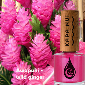 awapuhi non toxic nail polish bottle next to wild ginger flowers