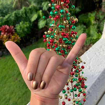  rainbows end natural nail polish shaka hand next to christmas tree