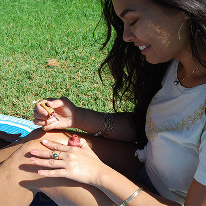girl painting her hands with blushing sun toxin free nail polish